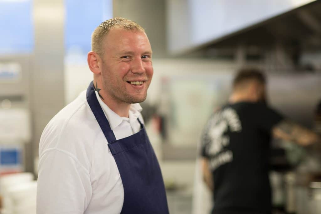 A male chef wearing an apron