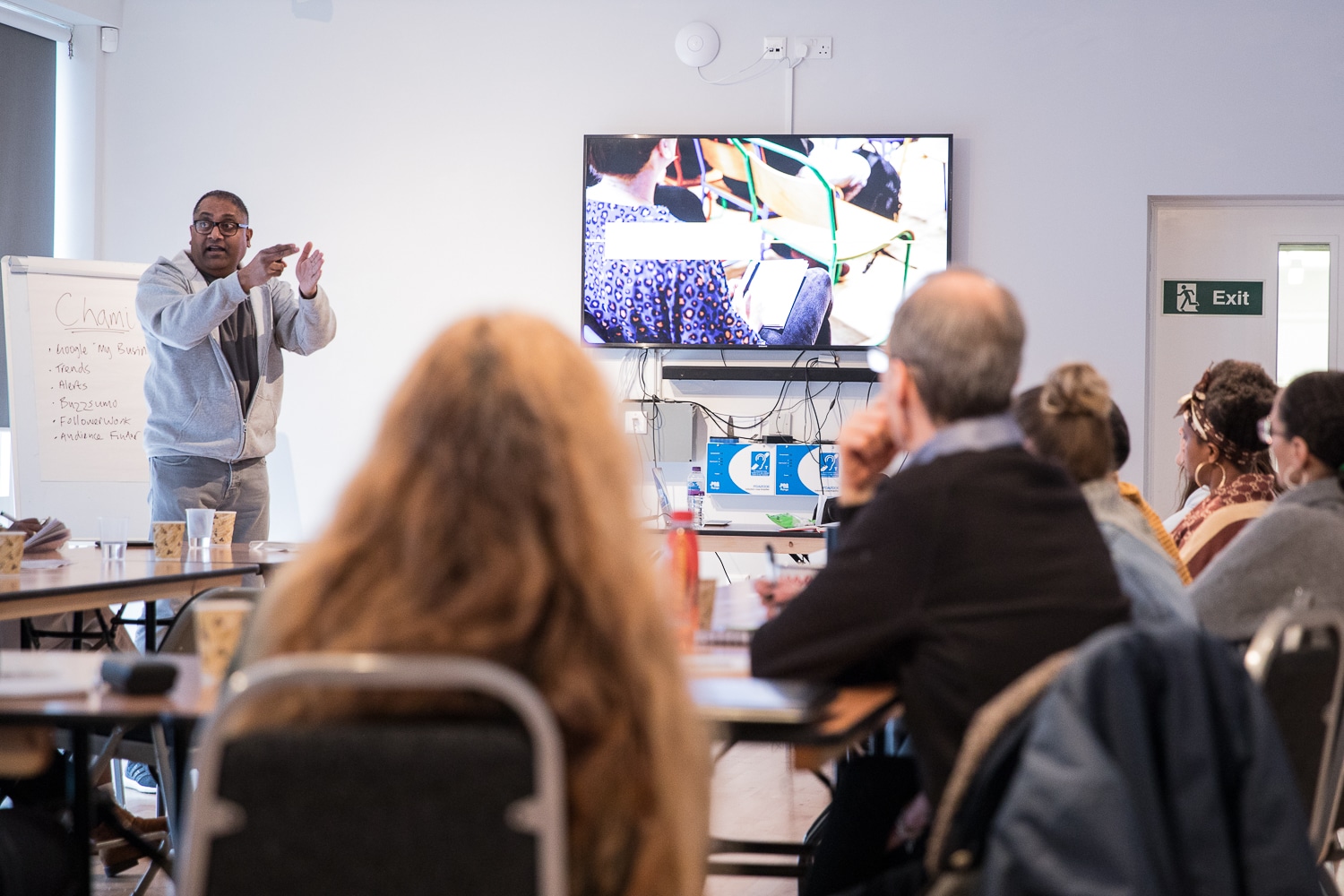 Man pointing while presenting a training course.