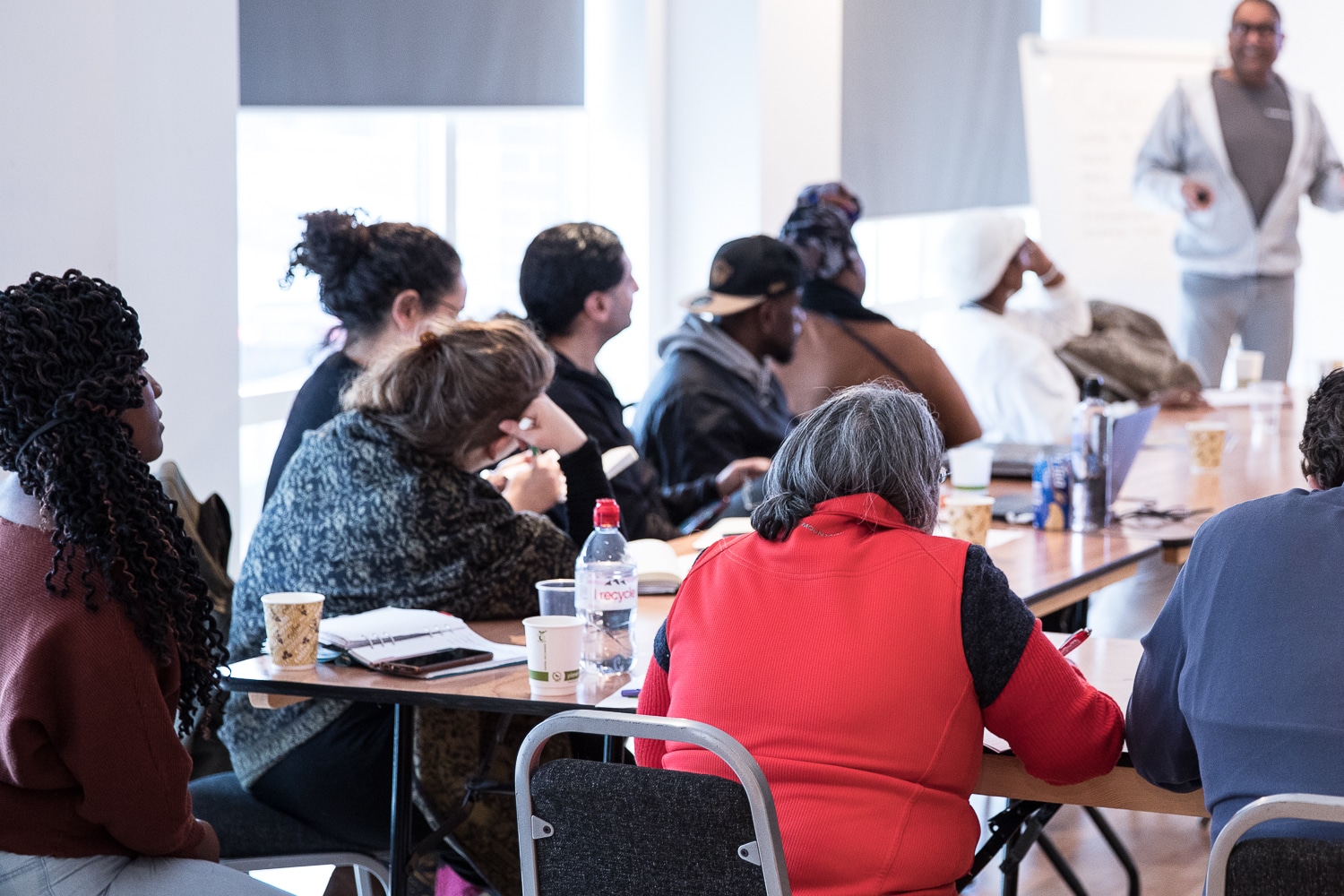 People sat around a conference table listening to a training session.