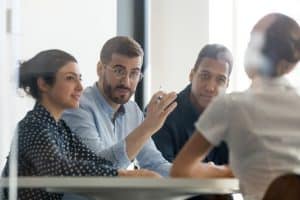 People having a meeting sat round a table